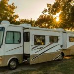 Motorhome sitting in shaded area.